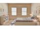 Bright bedroom with two windows, neutral walls and carpet, complemented by tastefully chosen decor and comfortable furnishings at 2205 Capella Sw Cir, Atlanta, GA 30331