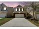 Charming two-story home featuring a two-car garage and manicured front lawn at sunset at 2205 Capella Sw Cir, Atlanta, GA 30331