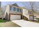 Charming two-story home featuring a two-car garage, brick accents, and a nice lawn at 2205 Capella Sw Cir, Atlanta, GA 30331