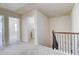 Upstairs hallway featuring neutral carpet, detailed railing, and multiple doorways at 2205 Capella Sw Cir, Atlanta, GA 30331