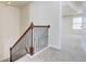 Second-floor hallway with carpet and wooden railing leading to bedroom at 2205 Capella Sw Cir, Atlanta, GA 30331