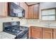 Close-up of the kitchen with a gas range and granite countertops at 2205 Capella Sw Cir, Atlanta, GA 30331