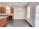 Dining area right off the kitchen boasts matching cabinets and modern chandelier at 2205 Capella Sw Cir, Atlanta, GA 30331