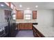 Stylish kitchen with dark wood cabinets, granite countertops, and stainless steel appliances at 2205 Capella Sw Cir, Atlanta, GA 30331