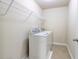 Laundry room equipped with a washer, dryer, and wire shelving for storage at 2205 Capella Sw Cir, Atlanta, GA 30331