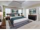 Staged main bedroom with tray ceilings, neutral tones, and large windows at 2205 Capella Sw Cir, Atlanta, GA 30331
