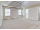 Spacious main bedroom showcasing large windows, tray ceiling, and neutral carpeting at 2205 Capella Sw Cir, Atlanta, GA 30331