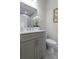 This bathroom features a gray vanity, modern mirror, and elegant decorative accents at 4256 Azalea Ridge Way, Hoschton, GA 30548