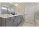 Bathroom featuring double vanity sinks, large mirror and tiled floors at 4256 Azalea Ridge Way, Hoschton, GA 30548