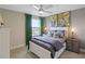 A cozy bedroom featuring a ceiling fan, natural light, and decorative accents at 4256 Azalea Ridge Way, Hoschton, GA 30548