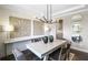 Dining room featuring wood-look accent wall, statement lighting, and elegant decor, creating a cozy yet stylish atmosphere at 4256 Azalea Ridge Way, Hoschton, GA 30548