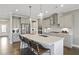 Gourmet kitchen with an island, stainless steel appliances, pendant lighting, and ample cabinet space for the avid cook at 4256 Azalea Ridge Way, Hoschton, GA 30548