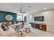 Cozy living room with modern decor, a comfortable sectional, and an entertainment center at 4256 Azalea Ridge Way, Hoschton, GA 30548