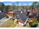 Stunning aerial view showcasing a brick home with a dark roof and well-maintained landscaping in a lovely community at 525 James Lee Dr, Suwanee, GA 30024