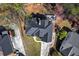 Aerial shot featuring a backyard deck, a dark roof, and lush greenery surrounding a well-maintained home at 525 James Lee Dr, Suwanee, GA 30024