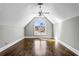 Finished attic space featuring a large arched window, wood floors, and ample natural light at 525 James Lee Dr, Suwanee, GA 30024