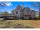 A home backyard showcasing a deck with stairs and a covered patio perfect for outdoor relaxation and activities at 525 James Lee Dr, Suwanee, GA 30024