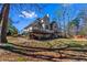 The home's backyard features a spacious deck, stairs, and covered patio with outdoor activities, creating an inviting outdoor space at 525 James Lee Dr, Suwanee, GA 30024
