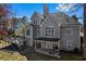 A view of the home's backyard featuring a spacious deck and a covered patio with outdoor activities at 525 James Lee Dr, Suwanee, GA 30024