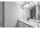 Bathroom with a single sink vanity, sleek black faucet, modern lighting, and a neutral color palette at 525 James Lee Dr, Suwanee, GA 30024