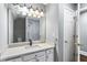Bathroom featuring a single sink vanity with black faucet, modern lighting, and a view of the shower area at 525 James Lee Dr, Suwanee, GA 30024