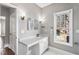 Bathroom with white cabinets, sink, and large window at 525 James Lee Dr, Suwanee, GA 30024