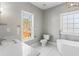 Bathroom featuring white tile and large tub at 525 James Lee Dr, Suwanee, GA 30024