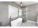 Bathroom featuring large soaking tub and glass shower at 525 James Lee Dr, Suwanee, GA 30024
