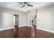 Spacious bedroom with tray ceiling, fan, hardwood floors, and convenient access to stairway at 525 James Lee Dr, Suwanee, GA 30024