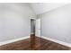 Spacious room with neutral gray walls and gleaming hardwood floors, ready for personalization at 525 James Lee Dr, Suwanee, GA 30024