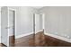 Bedroom with dark wood floors and an open closet at 525 James Lee Dr, Suwanee, GA 30024
