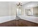 Formal dining room with hardwood floors, wainscoting, and a large mirror reflecting the chandelier at 525 James Lee Dr, Suwanee, GA 30024