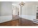 A view of the dining room that shows the gleaming hardwood floors, white trim and wall panels at 525 James Lee Dr, Suwanee, GA 30024