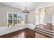 Elegant dining room features hardwood floors, large windows, and decorative chandelier lighting at 525 James Lee Dr, Suwanee, GA 30024