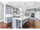 Kitchen boasts ample gray cabinetry, stainless appliances and a large island with white countertops at 525 James Lee Dr, Suwanee, GA 30024