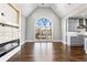 Spacious living room featuring a vaulted ceiling, large window, and stylish kitchen design at 525 James Lee Dr, Suwanee, GA 30024