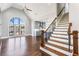 Open floorplan with stairs leading up to a kitchen with gray cabinets and an open living space at 525 James Lee Dr, Suwanee, GA 30024