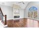 Bright living room with a vaulted ceiling, a fireplace, and large windows with views of the trees at 525 James Lee Dr, Suwanee, GA 30024