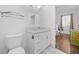 Clean bathroom with a white vanity, modern fixtures, and a toilet at 5300 Peachtree Rd # 1212, Atlanta, GA 30341