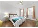 Serene bedroom featuring a ceiling fan, natural light, and simple decor at 5300 Peachtree Rd # 1212, Atlanta, GA 30341