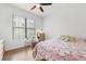 Bright bedroom with wooden floor, ceiling fan and large window providing natural light at 5300 Peachtree Rd # 1212, Atlanta, GA 30341