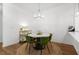 Modern dining area featuring a round table with green chairs and stylish chandelier at 5300 Peachtree Rd # 1212, Atlanta, GA 30341