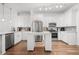 Modern kitchen with white cabinetry, stainless steel appliances, and a spacious island at 5300 Peachtree Rd # 1212, Atlanta, GA 30341