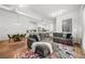 Cozy living area with an open concept, showcasing a sectional sofa and vibrant floral rug at 5300 Peachtree Rd # 1212, Atlanta, GA 30341