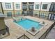 Community pool and hot tub with decorative fountain and surrounding wrought iron fence at 5300 Peachtree Rd # 1212, Atlanta, GA 30341