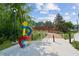 Colorful modern art sculpture in a landscaped park setting with bridge at 5300 Peachtree Rd # 1212, Atlanta, GA 30341