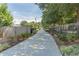 Landscaped walking path with trees and plantings along a fenced walkway at 5300 Peachtree Rd # 1212, Atlanta, GA 30341