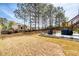 Expansive backyard with a stone patio featuring an outdoor dining set and grill, ideal for gatherings at 161 Dorys Way, Dallas, GA 30157