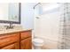 Cozy bathroom featuring a granite vanity, updated faucet and shower with a striped curtain at 161 Dorys Way, Dallas, GA 30157
