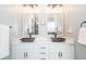 Modern bathroom featuring a double vanity, granite countertop, and stylish fixtures at 161 Dorys Way, Dallas, GA 30157